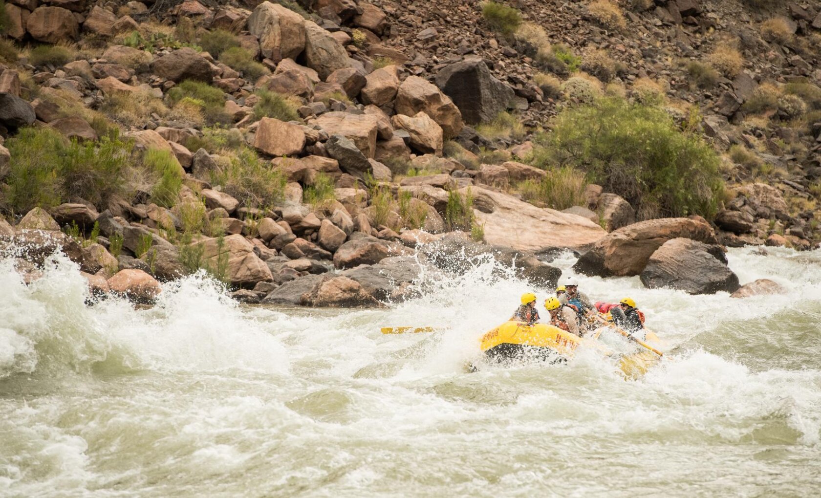 A raft going through rapids in Grand Canyon