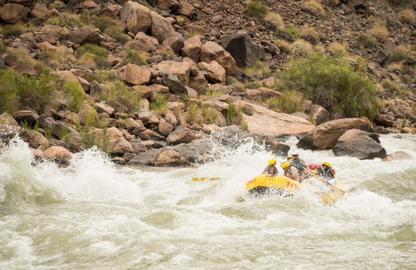 A raft going through rapids in Grand Canyon