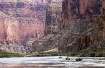 Dories against the massive walls of the Marble Canyon section of Grand Canyon.