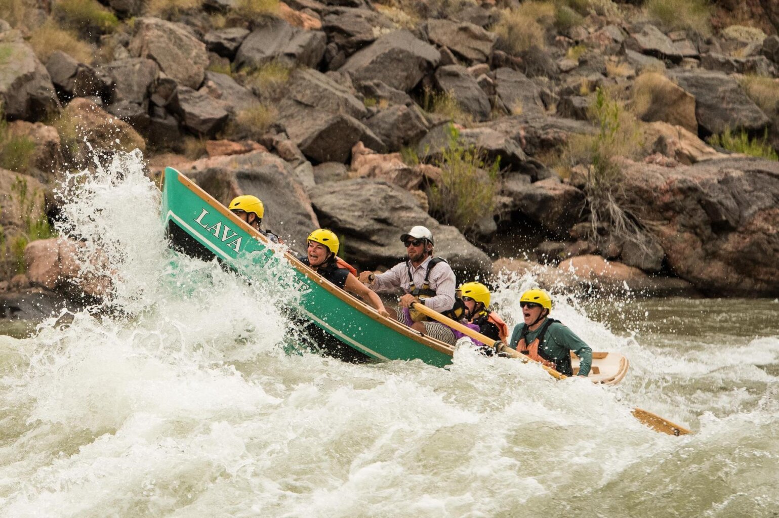 A dory charges through rapids in Grand Canyon