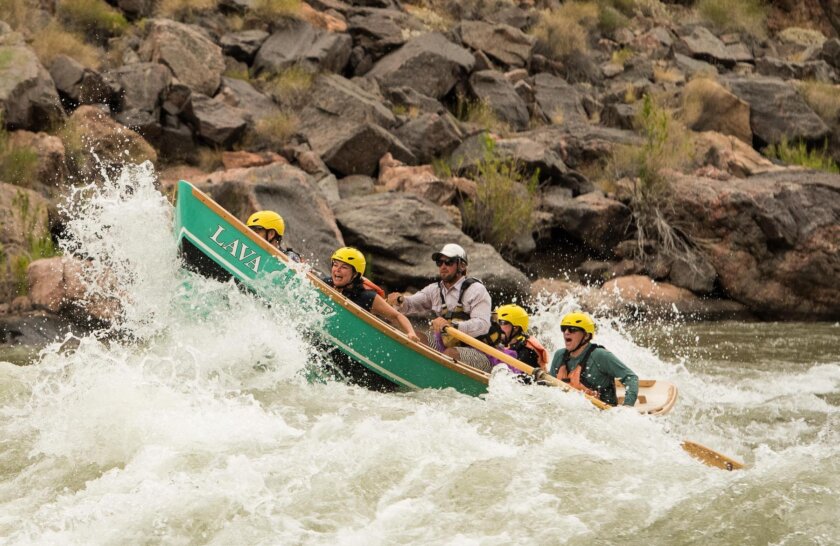 A dory charges through rapids in Grand Canyon
