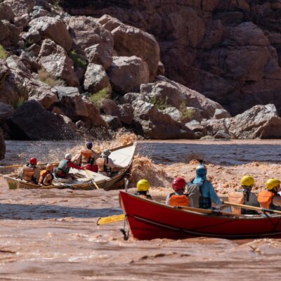 A pair of OARS dories going through a rapid on the Colorado River