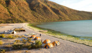 View from above of camp set up on the beach next to the ocean on a Sea Kayaking Espiritu Santo Island trip in Baja Mexico