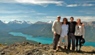 A family stands together at the top of an overlook in Alaska