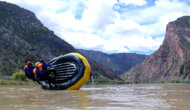 Three guides practice correcting a flipped raft during Dinosaur Whitewater Guide School training