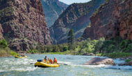 Two yellow OARS rafts full of people on the Green River through the Gates of Lodore.