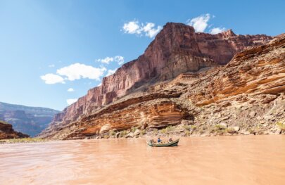A dory drifts through Grand Canyon on a sunny day.