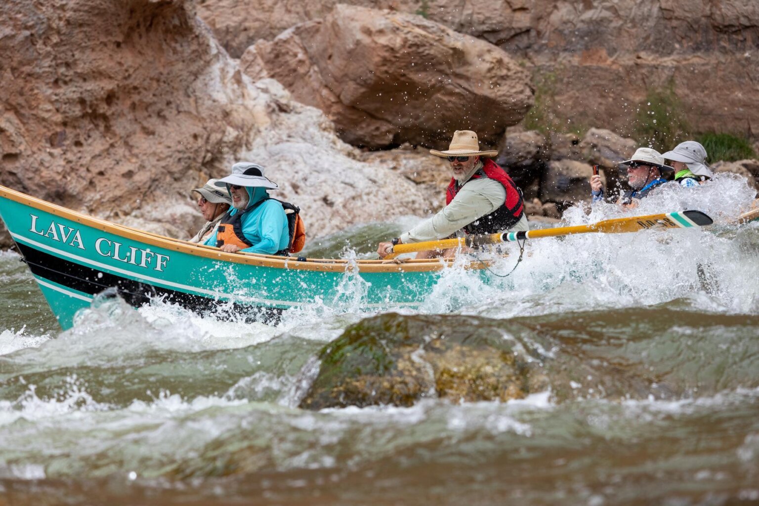 A dory making its way through a small rapid in Grand Canyon