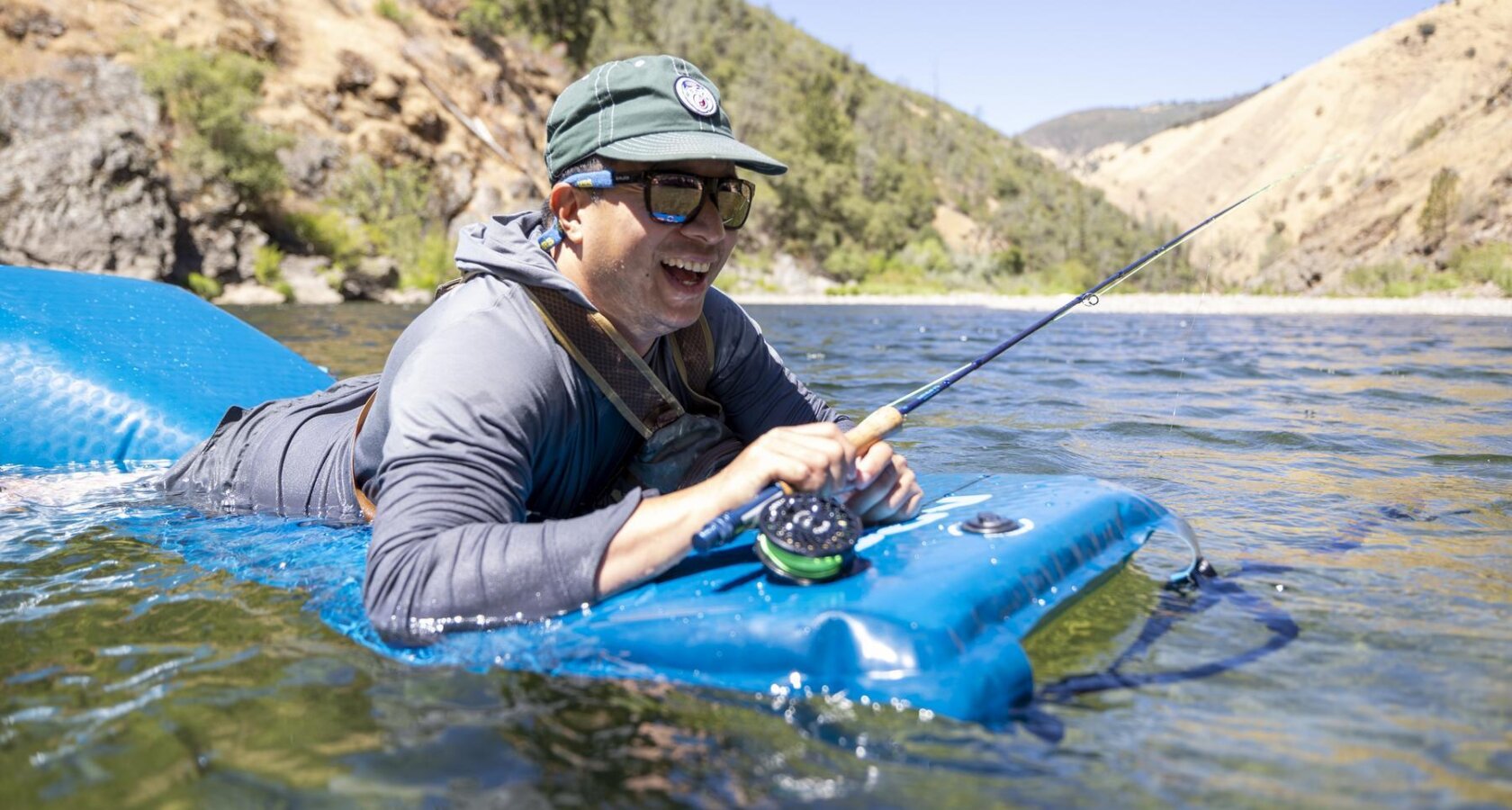 A fly fishermen floats in the Tuolumne River