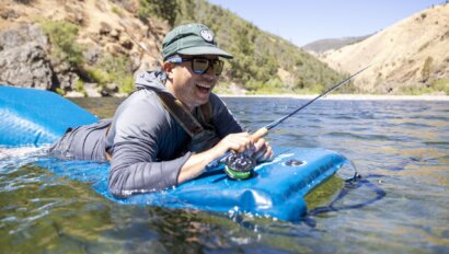 A fly fishermen floats in the Tuolumne River