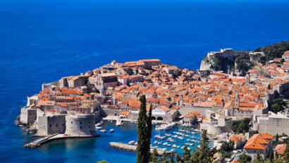 Aerial shot of Dubrovnik in Croatia featuring the town's historic red roofs
