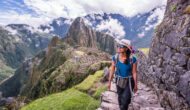 A woman explorers the ancient Incan empire of Machu Picchu.