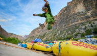 Kid jumping off a raft onto the river bank on the Green River through Gates of Lodore.