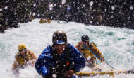People rafting through whitewater rapids.