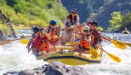 A group of people white water rafting.