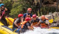A group of people white water rafting.