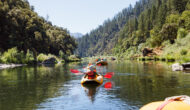 Yellow oar rafts and inflatable kayakers paddle down the Lower Klamath River