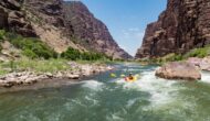 Inflatable kayakers maneuver through a rapid on the Green River through Gates of Lodore.