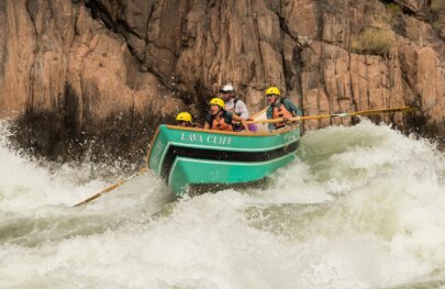 Passengers in a dory make it through a rapid on the Colorado River through Grand Canyon.