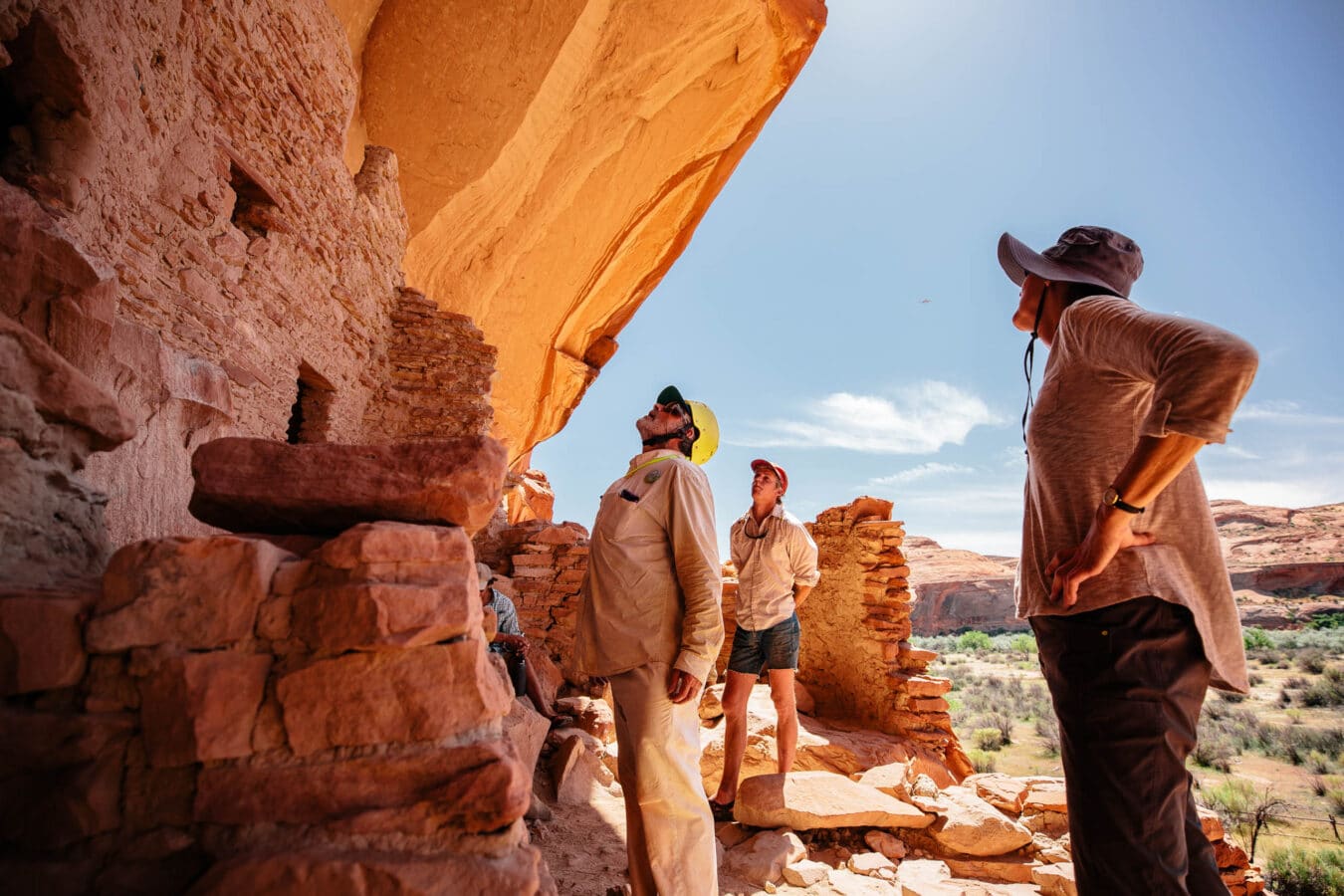 Guide and guests looking at a monument.