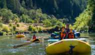 Groups of rafters having a good time on a river.