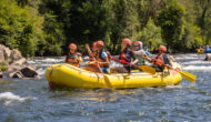 Group of youth rafting down a river.