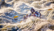 Group rafting through rapids.