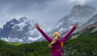 A hiker celebrates hiking the W Trek in Patagonia