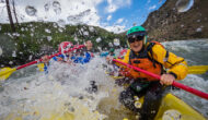 Two people encapsulated by a whitewater waver on a rafting trip