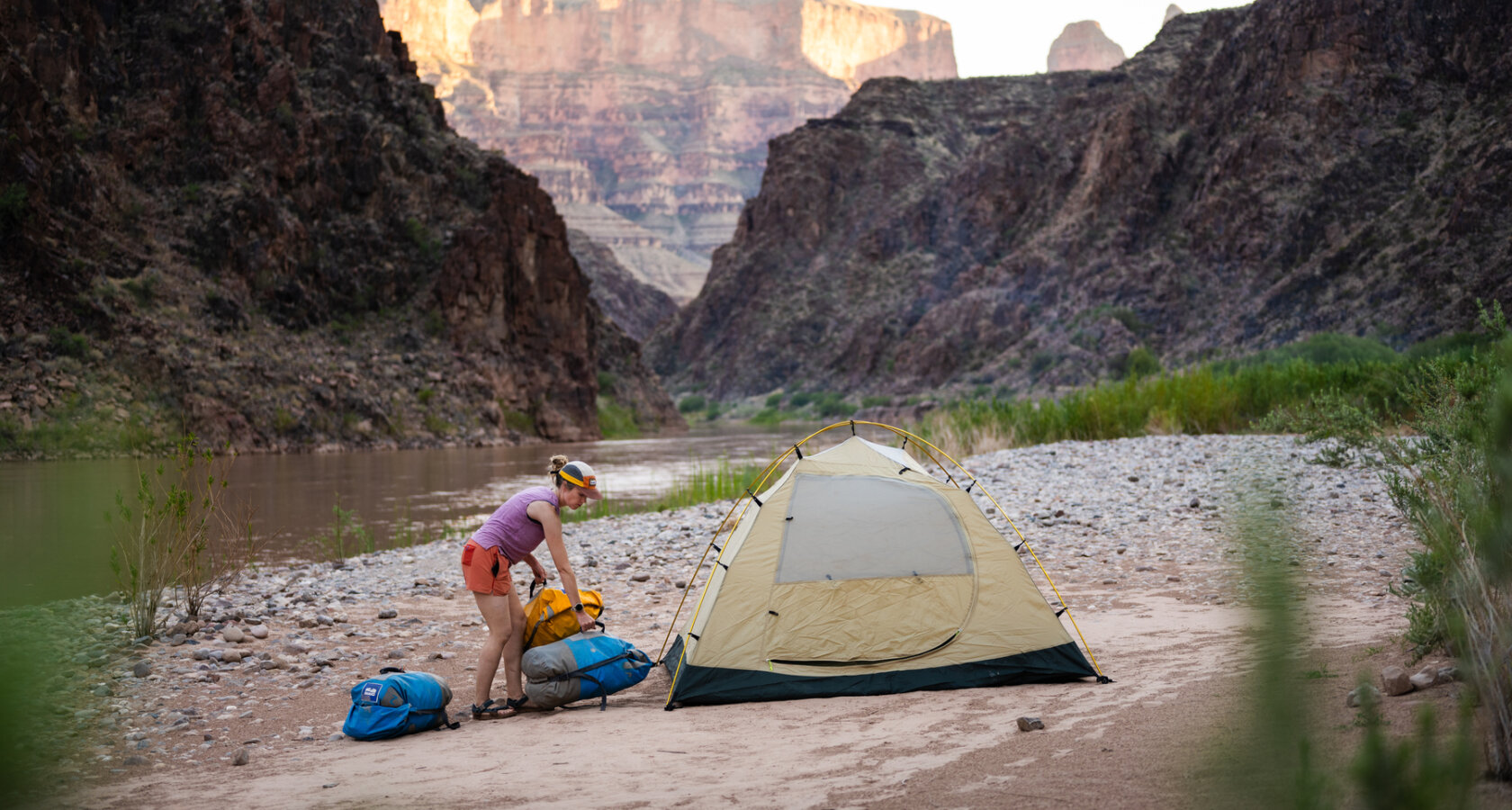 A woman sets up her campsite along the Colorado River in Grand Canyon
