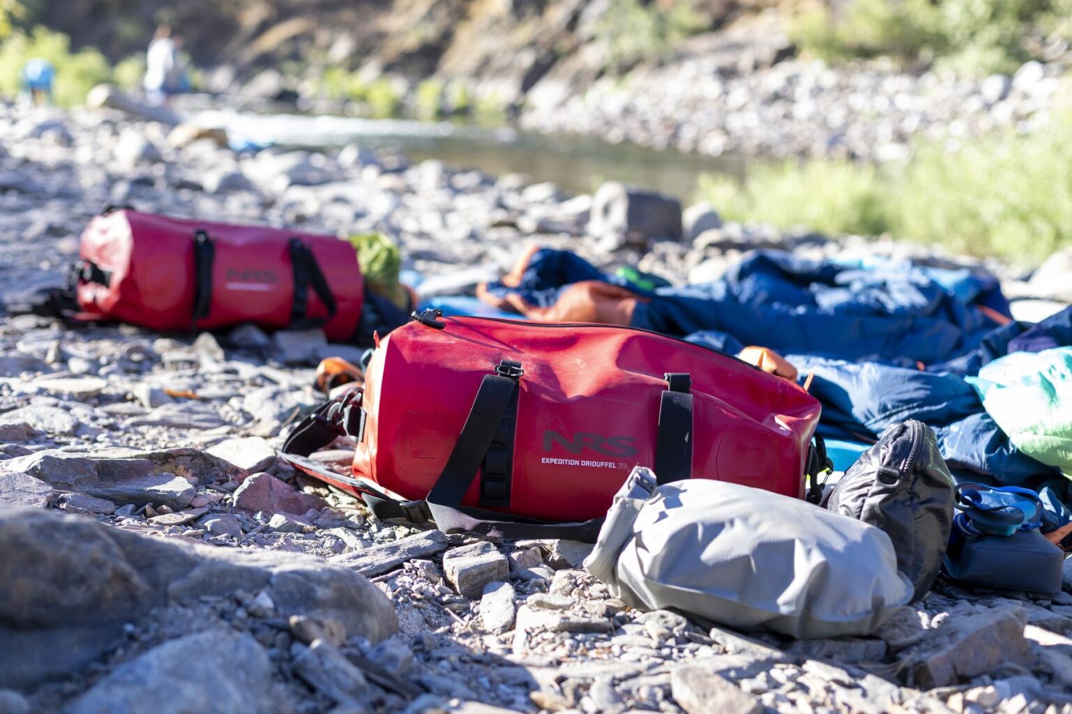 Red NRS Expedition DriDuffels in use on the Tuolumne River.