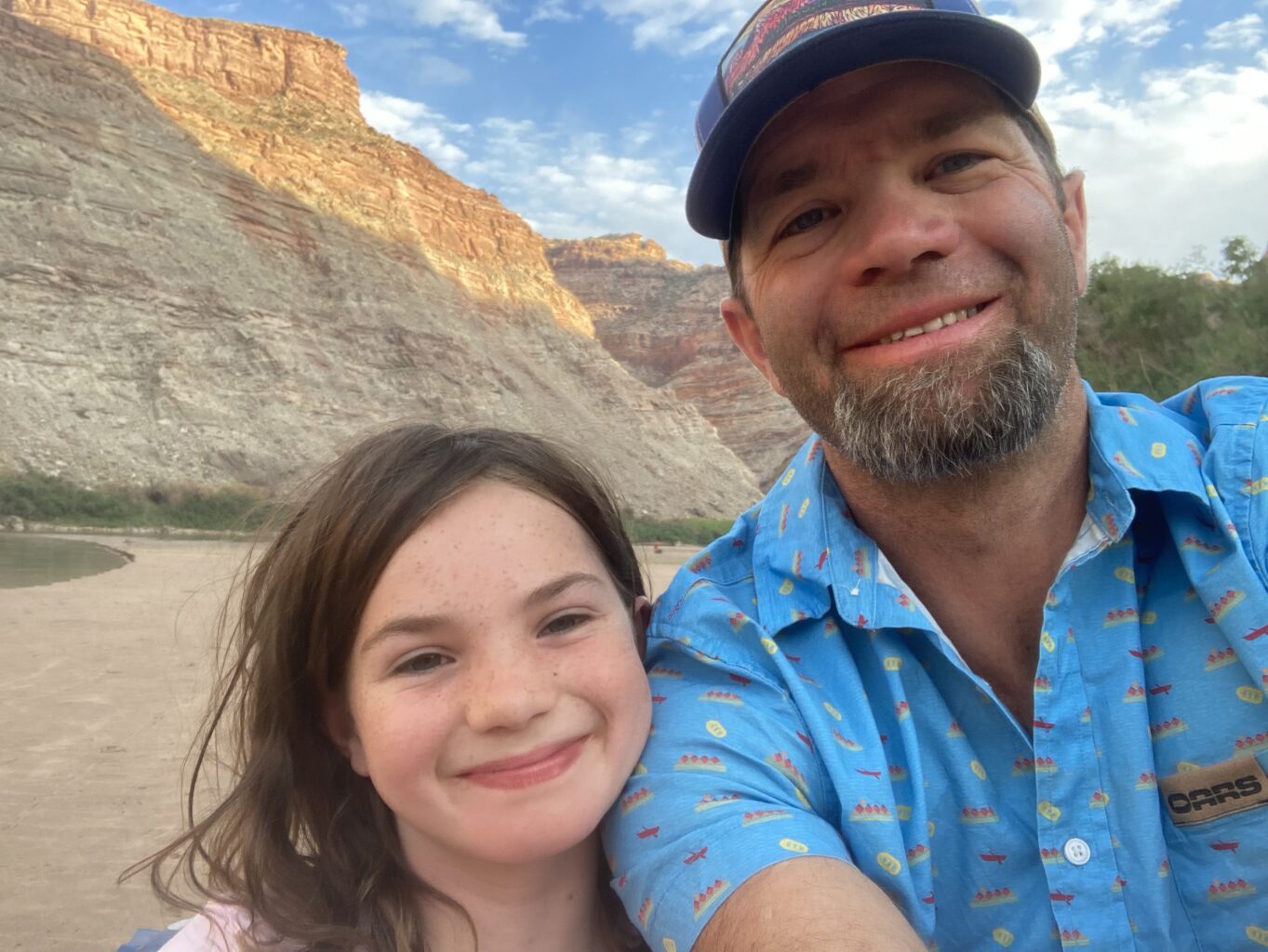 Seth Davis, OARS Director of Operations, and his daughter Lily on the beach along the Colorado River on a Cataract Canyon rafting trip