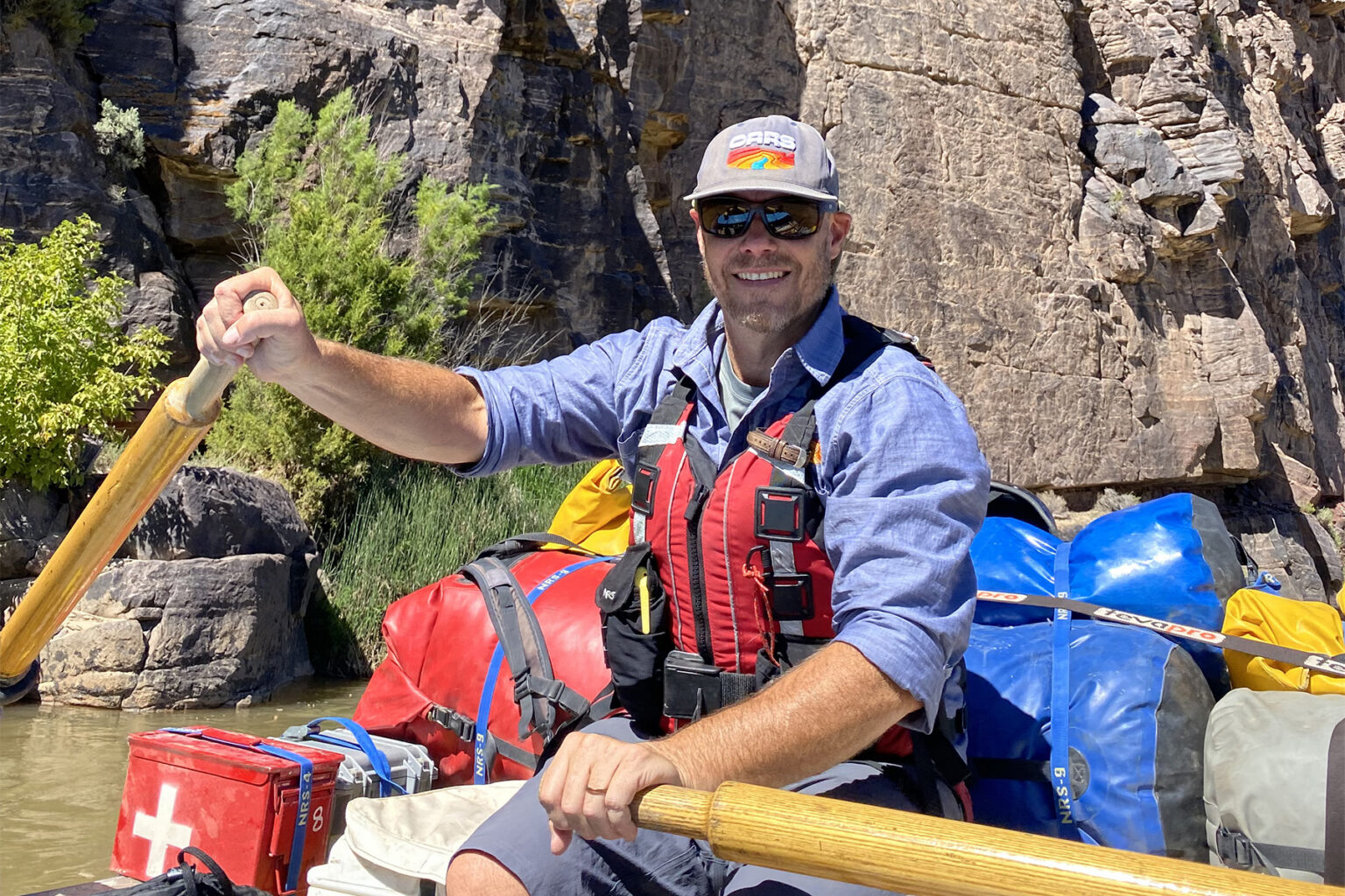 OARS President Tyler Wendt rowing a raft on the Green River