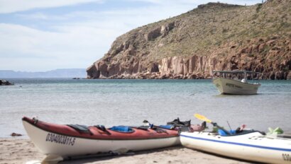 Kayaks rest on a beach on an island in the Sea of Cortez