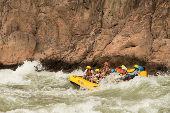 An oar raft running whitewater in Grand Canyon