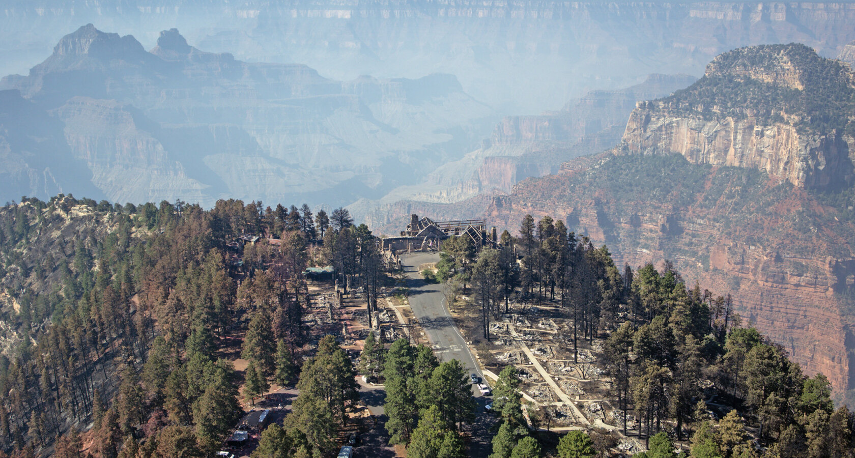 Smoke from the Dragon Bravo Fire in Grand Canyon with the remains of the Grand Canyon Lodge in the foreground.