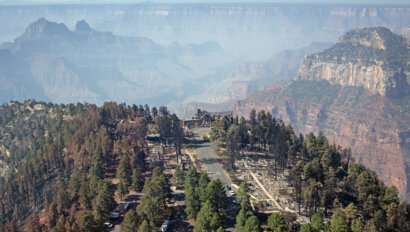 Smoke from the Dragon Bravo Fire in Grand Canyon with the remains of the Grand Canyon Lodge in the foreground.