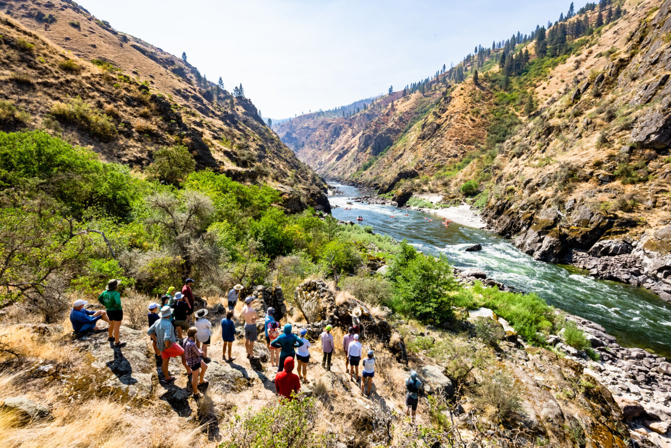 A group of rafters gather above the Lower Salmon River on a hike