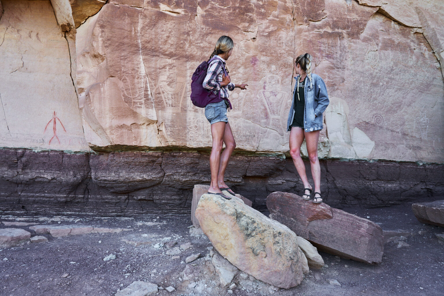 Two women standing in front of the  McConkie Ranch Main Panel of Classic Vernal Style Fremont rock imagery.